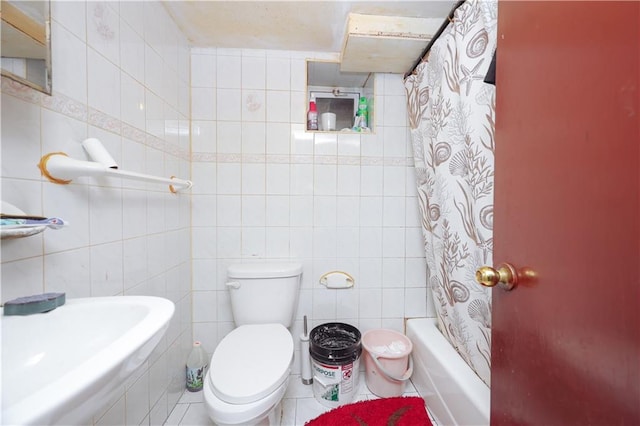 full bathroom featuring shower / bath combo, tile walls, and toilet