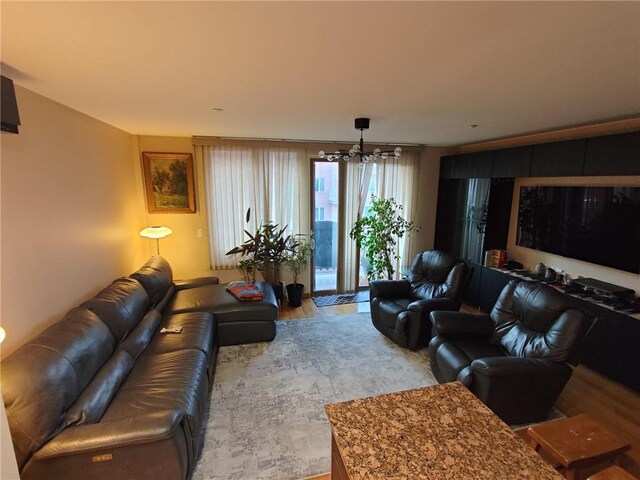 living room featuring a chandelier and light hardwood / wood-style floors