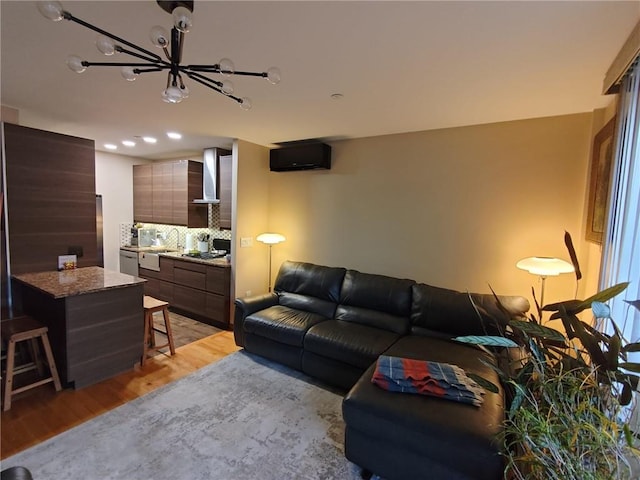 living room featuring light wood-type flooring and a chandelier