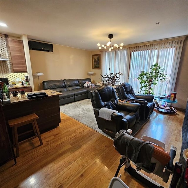 living room featuring light wood-type flooring and a notable chandelier