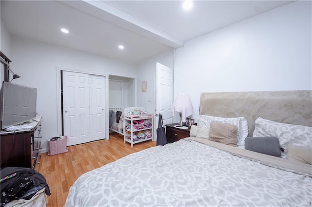 bedroom with beam ceiling and wood-type flooring