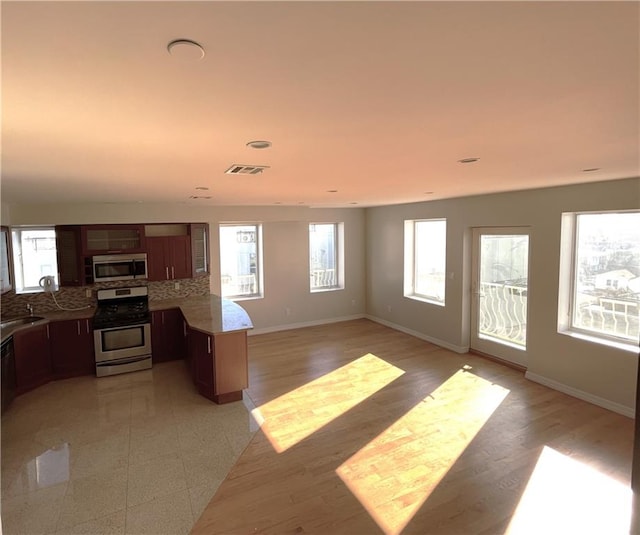 living room featuring sink and light hardwood / wood-style floors