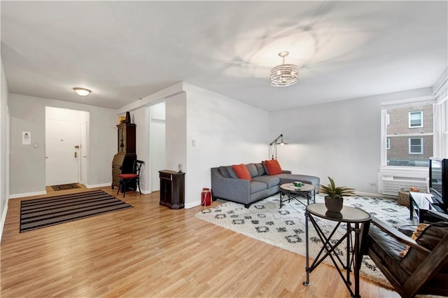 living room featuring an inviting chandelier and light hardwood / wood-style flooring