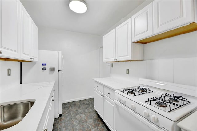 9411 Shore Rd Unit 1A, Brooklyn, NY 11209 - kitchen with white gas range, white cabinets, and light stone countertops