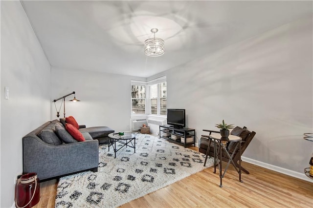 living room with hardwood / wood-style floors and a chandelier