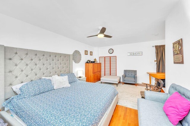 bedroom featuring hardwood / wood-style floors and ceiling fan