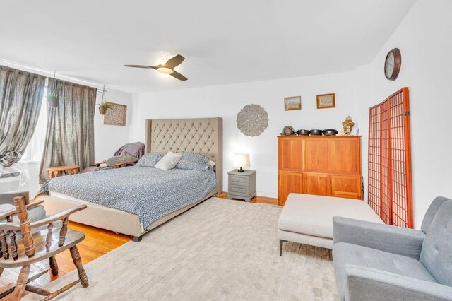 bedroom with ceiling fan and wood-type flooring