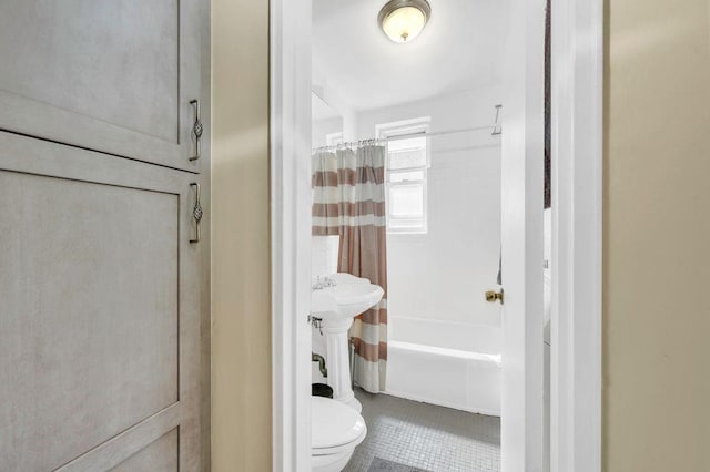 full bathroom with shower / tub combo, sink, tile patterned flooring, and toilet