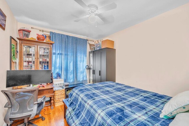 bedroom featuring wood-type flooring and ceiling fan