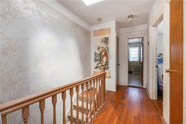 corridor with dark hardwood / wood-style flooring