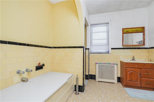 bathroom featuring tile walls, tile patterned flooring, vanity, and radiator heating unit