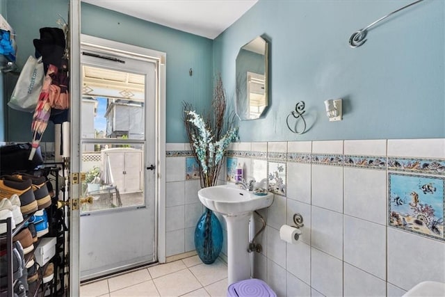 bathroom with tile patterned floors and tile walls