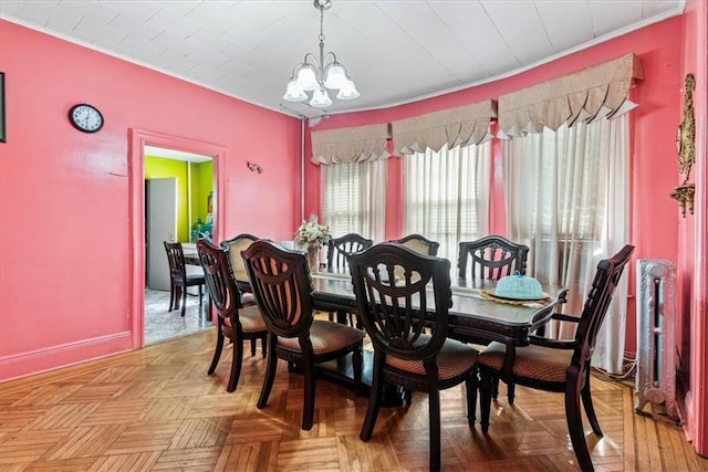 dining room featuring light parquet flooring and a chandelier