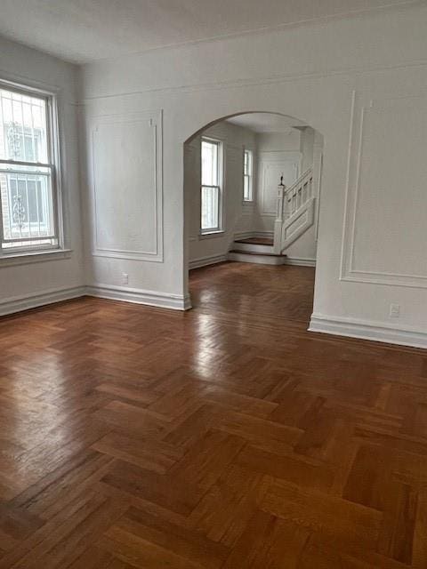 spare room with dark parquet floors