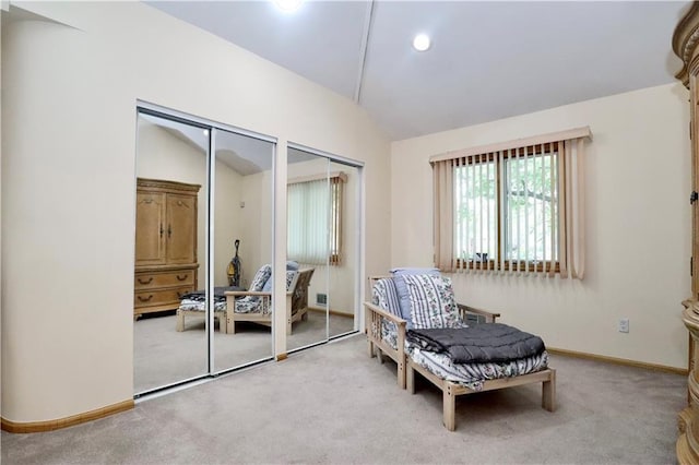 living area with light colored carpet and vaulted ceiling