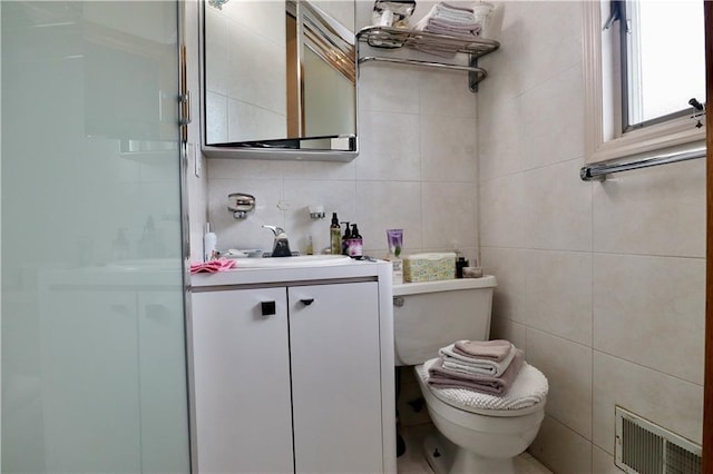 bathroom with vanity, an enclosed shower, tile walls, toilet, and decorative backsplash