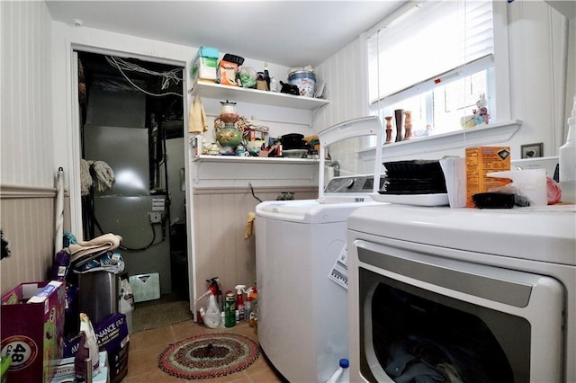 laundry room with separate washer and dryer and light tile patterned flooring