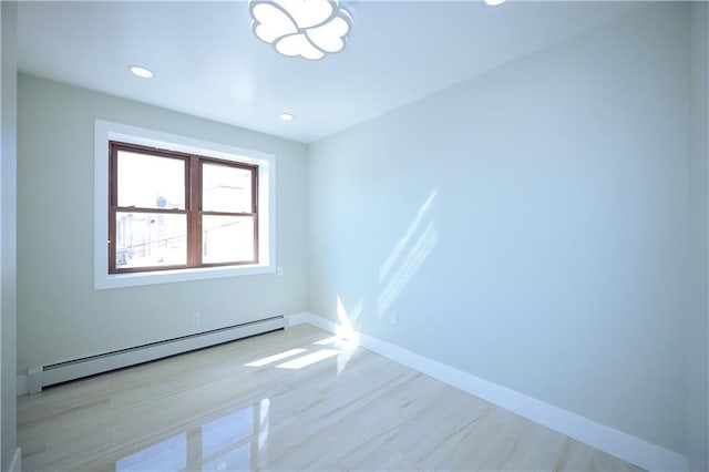 empty room featuring a baseboard heating unit, recessed lighting, and baseboards