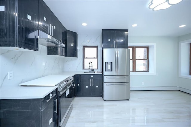 kitchen featuring dark cabinetry, a wealth of natural light, and stainless steel appliances