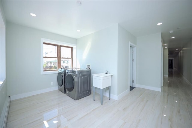 clothes washing area featuring baseboards, laundry area, recessed lighting, separate washer and dryer, and a baseboard radiator