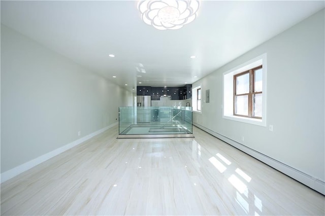 interior space with recessed lighting, light wood-style floors, baseboards, baseboard heating, and a chandelier