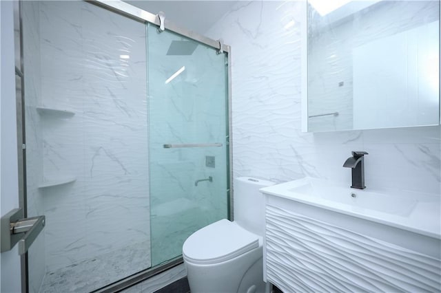 bathroom featuring a marble finish shower, toilet, tile walls, and vanity