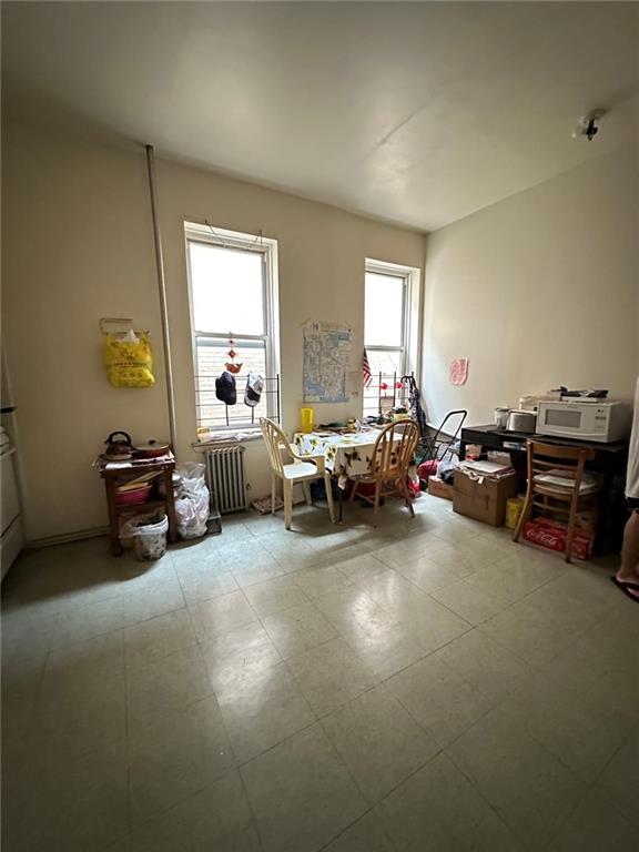 misc room with a healthy amount of sunlight and radiator