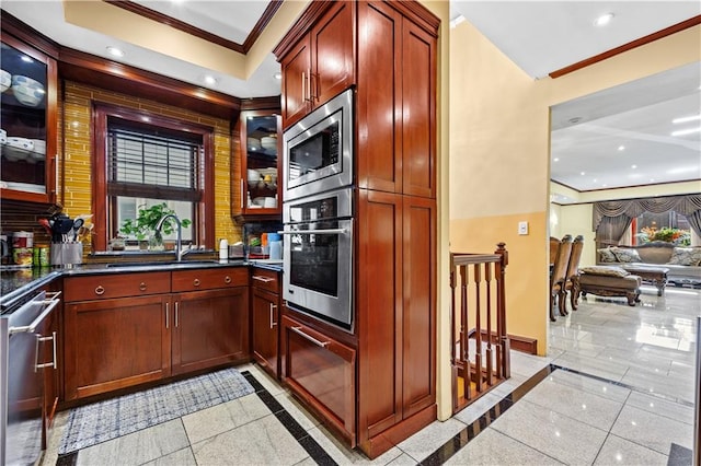 kitchen with appliances with stainless steel finishes, sink, and ornamental molding