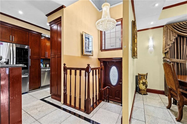 entrance foyer with crown molding and an inviting chandelier