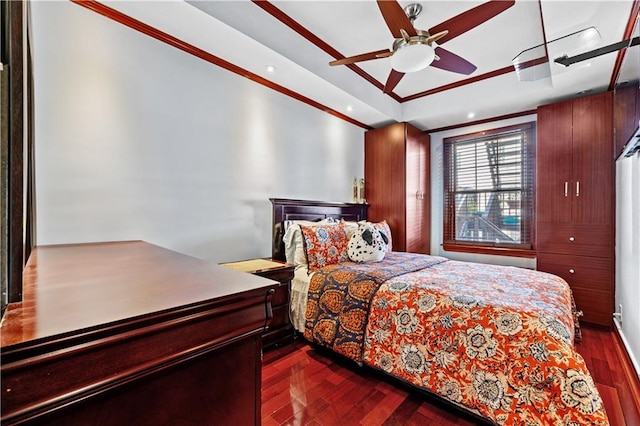 bedroom featuring crown molding, dark hardwood / wood-style floors, and ceiling fan