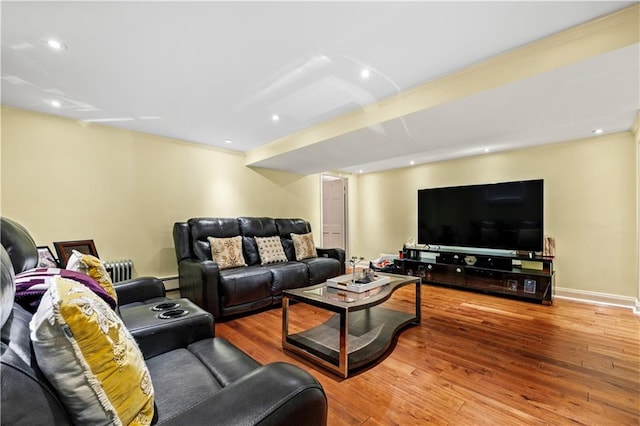 living room featuring radiator, wood-type flooring, and a baseboard radiator