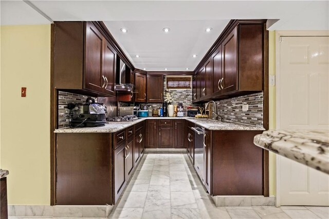 kitchen with dark brown cabinets, light stone counters, stainless steel appliances, and backsplash