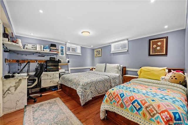 bedroom with crown molding and hardwood / wood-style flooring