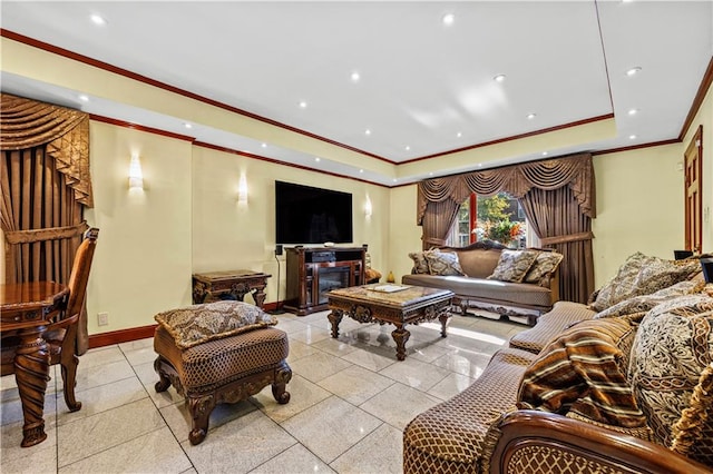 living room featuring ornamental molding, a fireplace, and a raised ceiling