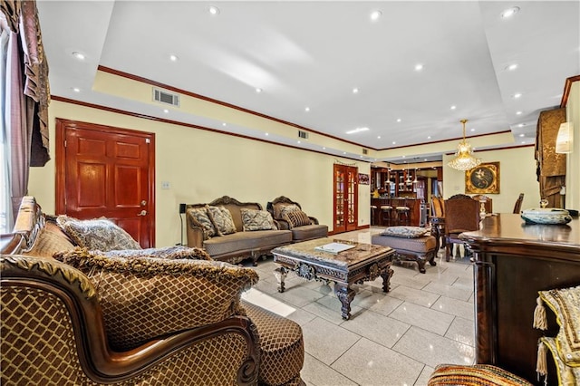 living room featuring ornamental molding and a raised ceiling