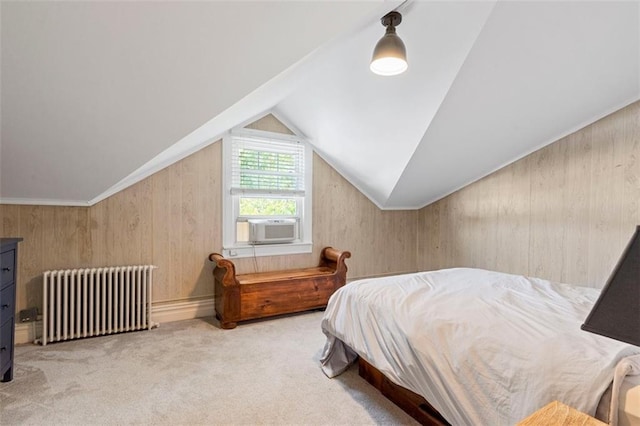 bedroom with carpet floors, wood walls, radiator heating unit, and lofted ceiling