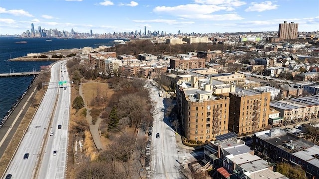 birds eye view of property featuring a water view and a city view