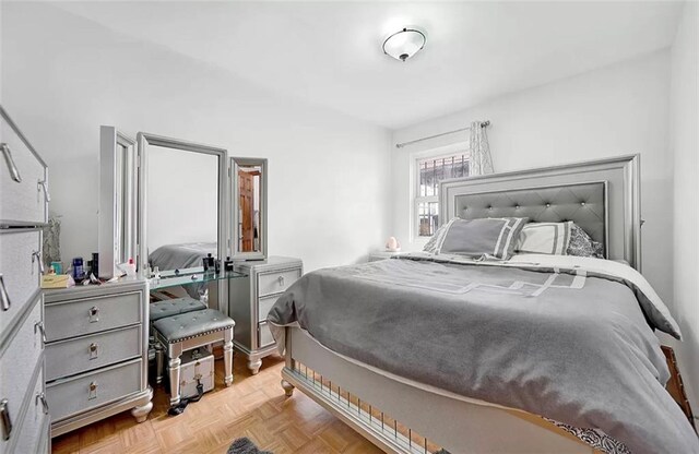 bedroom featuring light parquet flooring