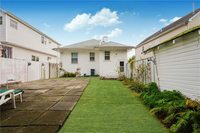 back of house with a yard and a patio area