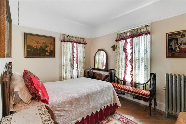 bedroom featuring radiator and wood-type flooring