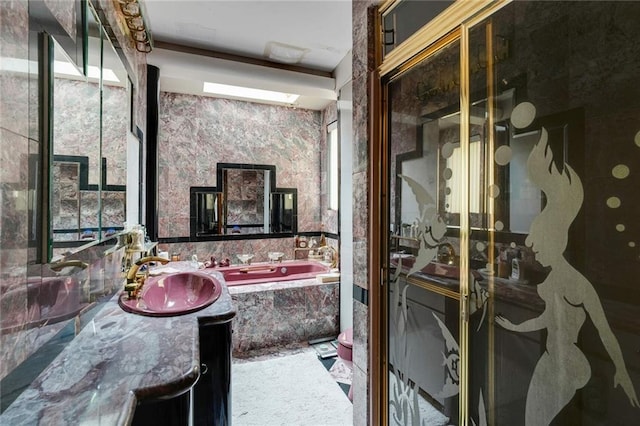 bathroom with vanity and tiled bath