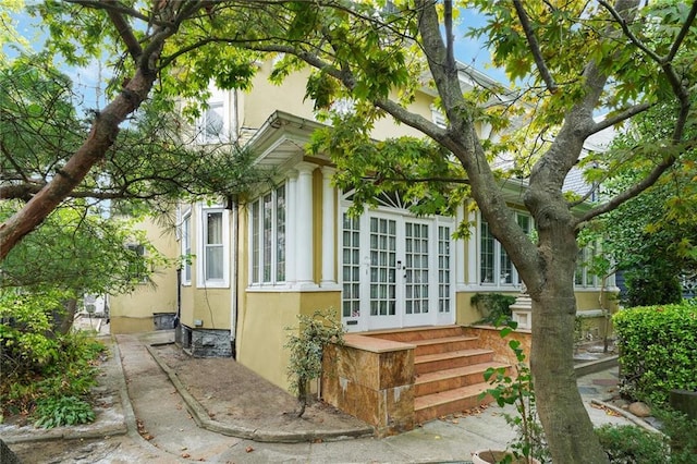 view of side of home with french doors