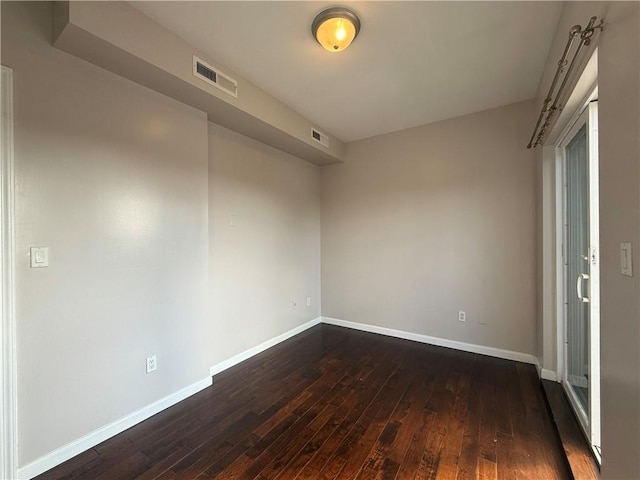 empty room with dark hardwood / wood-style floors