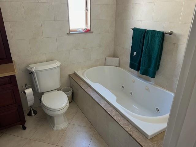 full bathroom with tile patterned flooring, toilet, tile walls, and a whirlpool tub