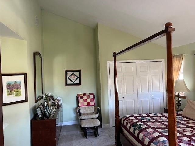 bedroom featuring a closet, vaulted ceiling, baseboards, and carpet floors