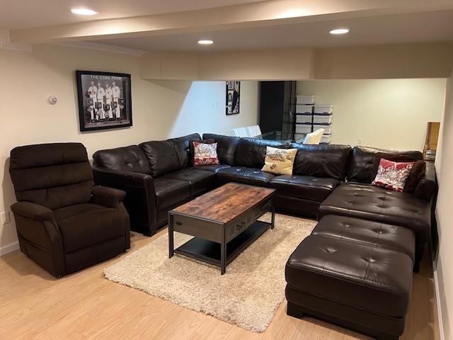 living room featuring recessed lighting, baseboards, and light wood finished floors