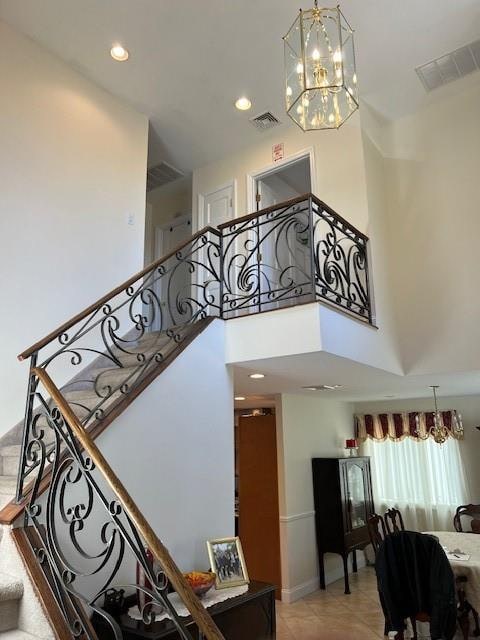 stairs featuring a towering ceiling