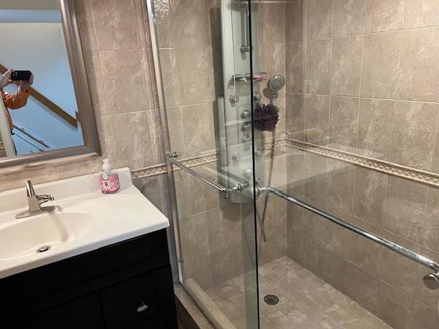 bathroom featuring vanity and a shower stall