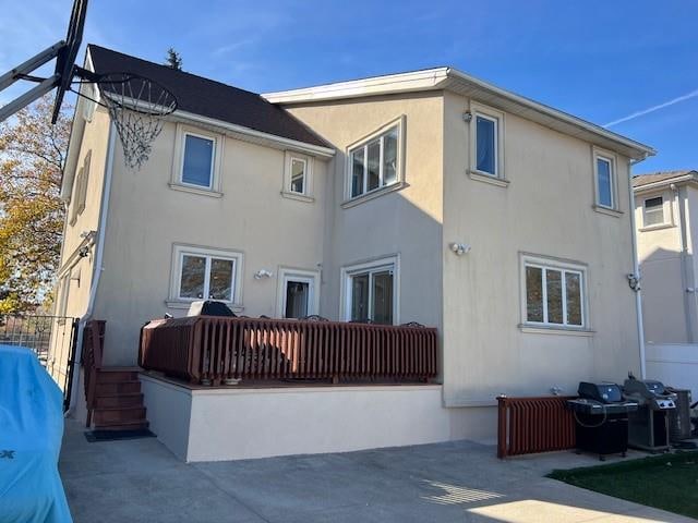 back of house with a patio area, fence, and stucco siding