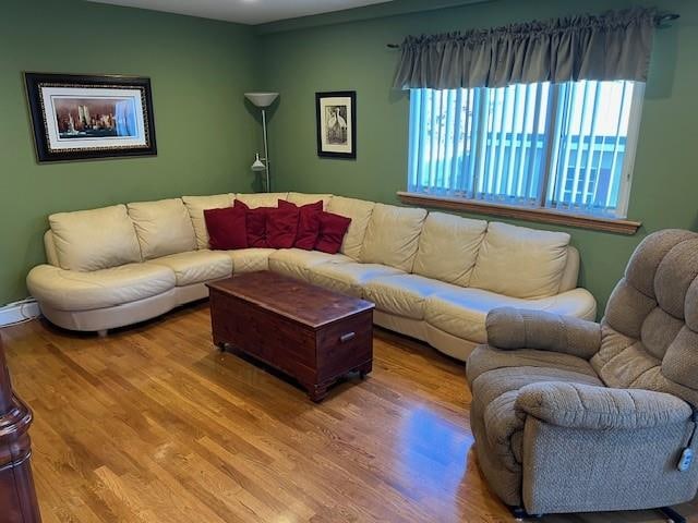 living room with wood finished floors and baseboard heating